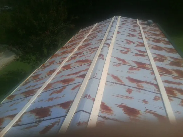 Rusted metal roof panels with new wood purlins before replacement — Storm Damage Roof Repair in Bearsville by Roofing Brothers