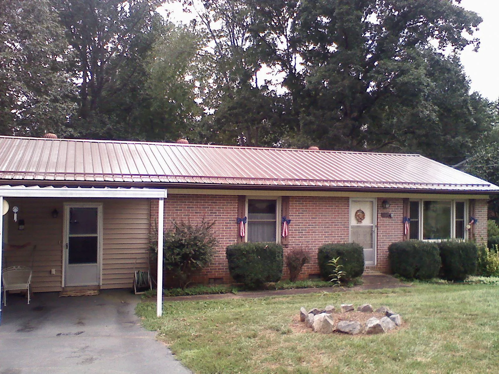 Bronze metal roof and carport on a brick ranch home — Roof Repair work by our crew in Bearsville